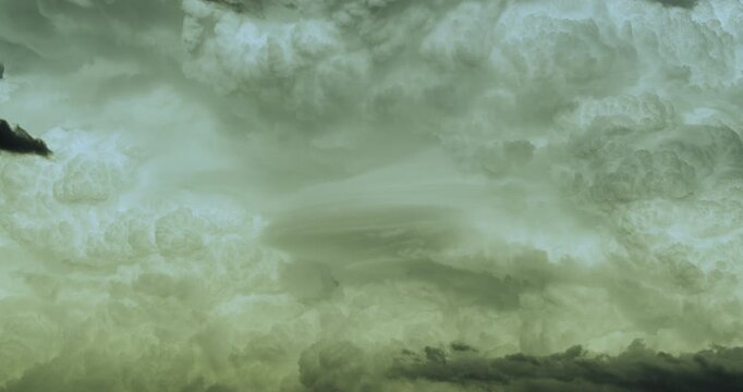 Timelapse of a fascinating and beautiful closeup view of a detail of a massive growing white cumulonimbus cloud forming supercell 