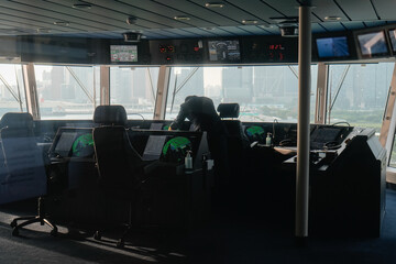 modern ship navigation bridge with captain overlooking the urban landscape