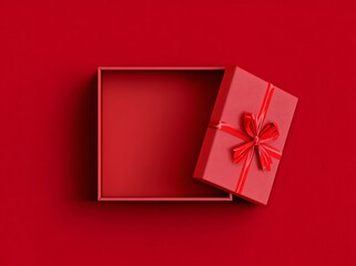 Red open gift box with ribbon bow isolated on a red background