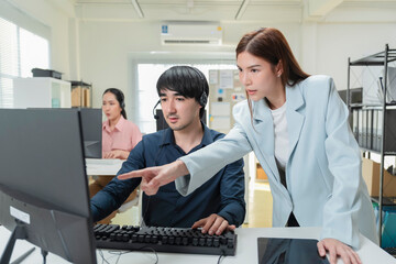Cheerful mature coworkers and confident operators cooperating on customer cases in call center,...