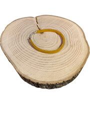 yellow bracelet on wood