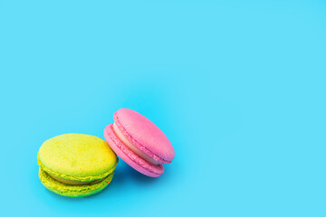 Mixed of colorful macaroni or pasta cake on a blue background. Sweet and colorful french macarons....