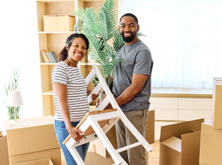 Portrait of a young couple unpacking, moving in, holding a plant and chair and relocation to a new...