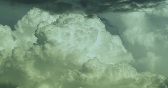 Timelapse of a fascinating and beautiful view of a massive growing white cumulonimbus cloud forming supercell 