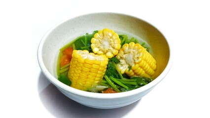 Spinach Clear Soup with Corns. Sayur bening bayam jagung served in white bowl, Indonesian popular food 