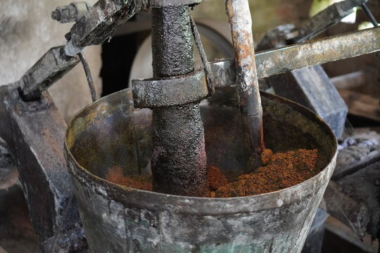 A traditional setup for extracting oil, likely mustard oil, using a 'ghani' or 'chekku' press