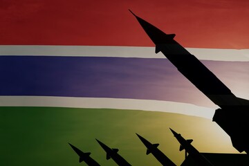 Silhouettes of missiles on a background of flag of Gambia. Copy space on the left side
