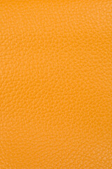 A detailed close-up reveals the textured surface of yellow artificial leather, suitable as a...
