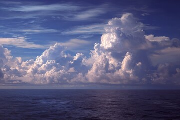 Scenic Distant Clouds Over Ocean: A Tranquil Daylight View of Sea and Sky with Gentle Sunlight