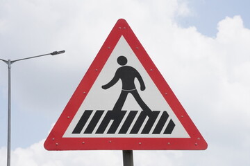 A pedestrian crossing warning sign, commonly known as a zebra crossing sign