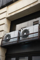 Air conditioning unit mounted on the wall provides cool air, air quality and heat source. Green...