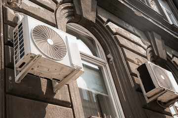 Air conditioning unit mounted on the wall provides cool air, air quality and heat source. Green...