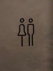Modern Unisex Restroom Sign on Concrete Wall