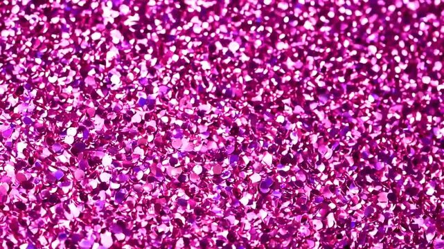 Glittering pink sequin background with sparkling reflective texture