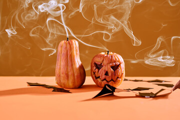 Halloween-style candles on a orange background. Festive decor.