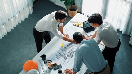 Top view of professional architect engineer team writing sticky notes and sticking note at meeting...
