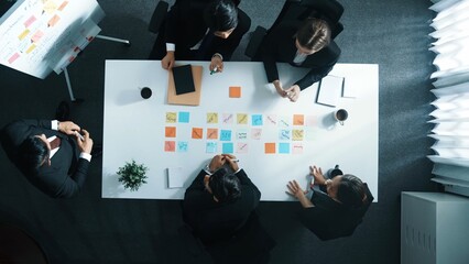 Top down aerial view of professional business people listening investor explain strategy at meeting...