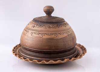 Brown Ceramic Plate with lid. Clay bowl dish on white background. Ukrainian handmade craft