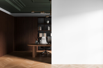 Modern interior workspace with dark wood decor and blank white wall for poster mockup or design...