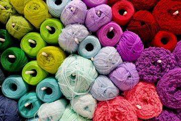These colorful pictures show a neatly arranged and colorful set of spools and bobbins. The yarn is neatly stacked.
