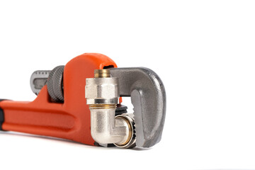 Adjustable pipe wrench with fitting on white background. Closeup.
