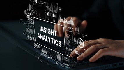 Hands typing on laptop with digital analytics and data visualization graphics representing insight...