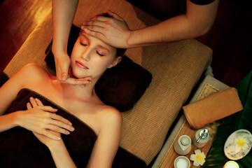 Caucasian woman enjoying relaxing anti-stress head massage and pampering facial beauty skin...