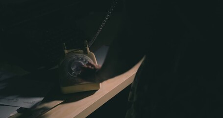 Making a call on an old rotary telephone