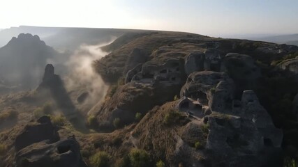 Discovering the Mystical Cave City A Journey Through Time and Mist Exploring Ancient Carved Structures with Natural - Powered by Adobe