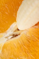 Detailed close-up photo of a fresh halved orange and banana. Symbol of male and female.