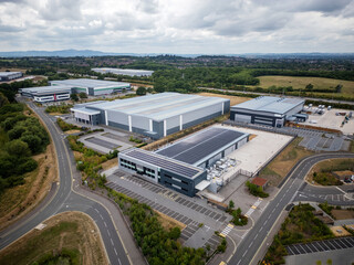 Industrial Park Aerial View Featuring Large Warehouses with Solar Panels, Extensive Road Network,...