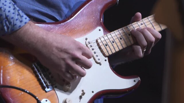 Musician playing electric guitar on stage