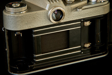 Old camera on a dark background close up. Shallow depth of field
