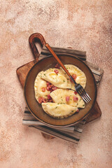 Dumplings, with fried prosciutto, a traditional dish of Polish cuisine, dumplings, top view, close-up, without people,