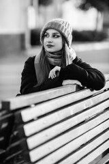 Portrait of a young beautiful long-haired girl in the early winter outdoors. Black and white photo.