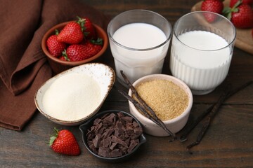 Different ingredients for panna cotta. Milk, sugar, vanilla, chocolate and strawberries on wooden...