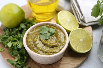 Tasty sauce with cilantro and other ingredients on white table, above view