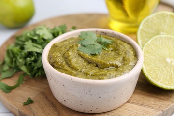 Tasty sauce with cilantro and other ingredients on table, closeup