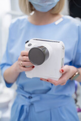 Healthcare Professional in uniform capturing moments with a camera in a clinical setting