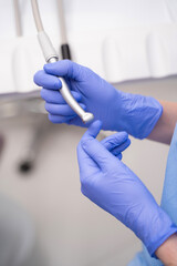 A dental professional meticulously preparing for an upcoming dental procedure at the clinic