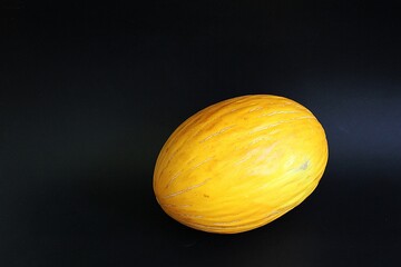 yellow melon, cantalupe melon, fruit on black background, juicy fruit