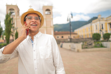 Young Latino man talking on his smartphone. Young Latino tourist in western Guatemala.