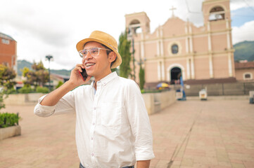 Young Latino man talking on his smartphone. Young Latino tourist in western Guatemala.