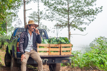 Adult farmer having a telephone conversation using a smartphone.