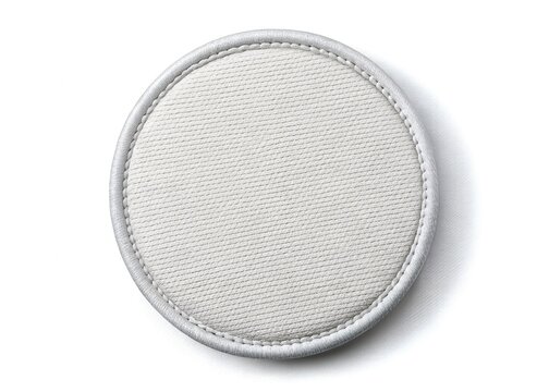 A round white fabric patch with stitched edges isolated on white
