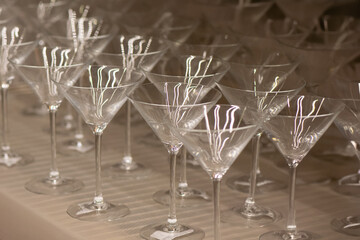 Assorted clear glass jars, stemware and carafes arranged in rows for retail sale