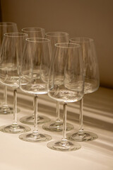 Assorted clear glass jars, stemware and carafes arranged in rows for retail sale