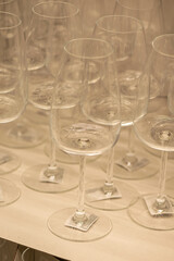 Assorted clear glass jars, stemware and carafes arranged in rows for retail sale