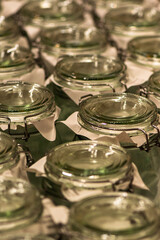 Assorted clear glass jars, stemware and carafes arranged in rows for retail sale