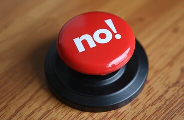 Bright red round button with bold white text no. centered on black base, placed on wooden surface. Simple yet impactful graphic represents clear rejection negative response, suitable for surveys,